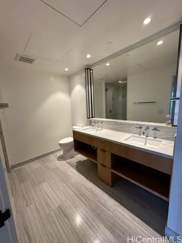 a bathroom with a sink double vanity and a large mirror