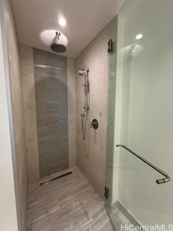 a bathroom with a shower and a glass door