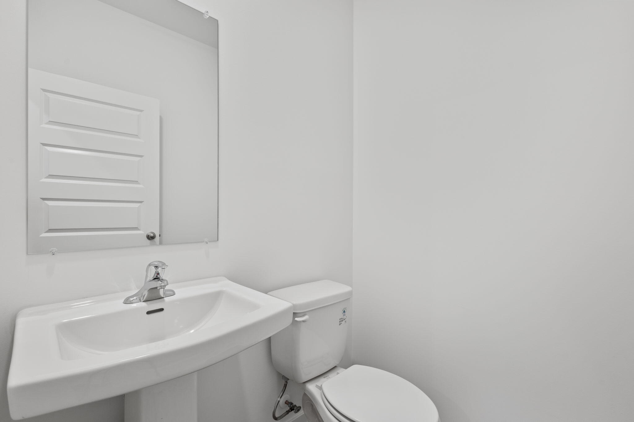 10588 Morse Place Crown Point, IN 46307 - Photo 11 of 28 a bathroom with a sink a toilet and mirror