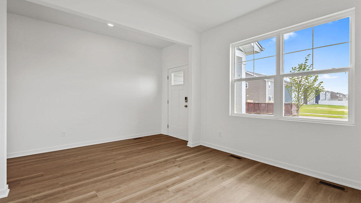 10588 Morse Place Crown Point, IN 46307 - Photo 12 of 28 a view of an empty room with a window and wooden floor