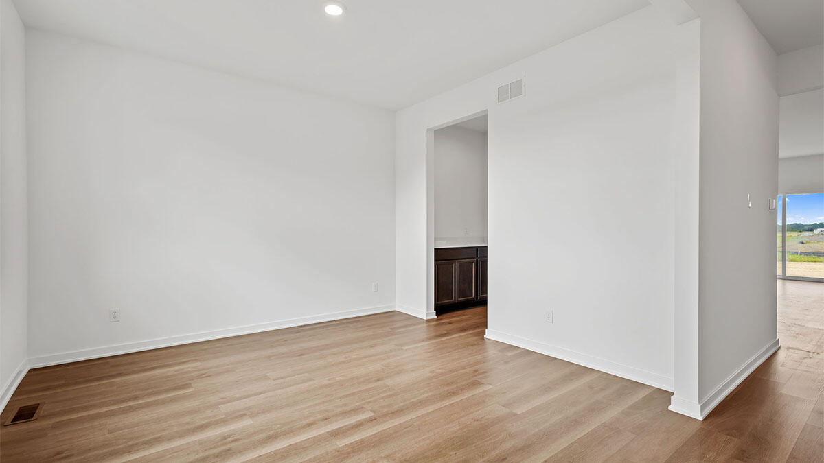 10588 Morse Place Crown Point, IN 46307 - Photo 13 of 28 a view of an empty room with wooden floor