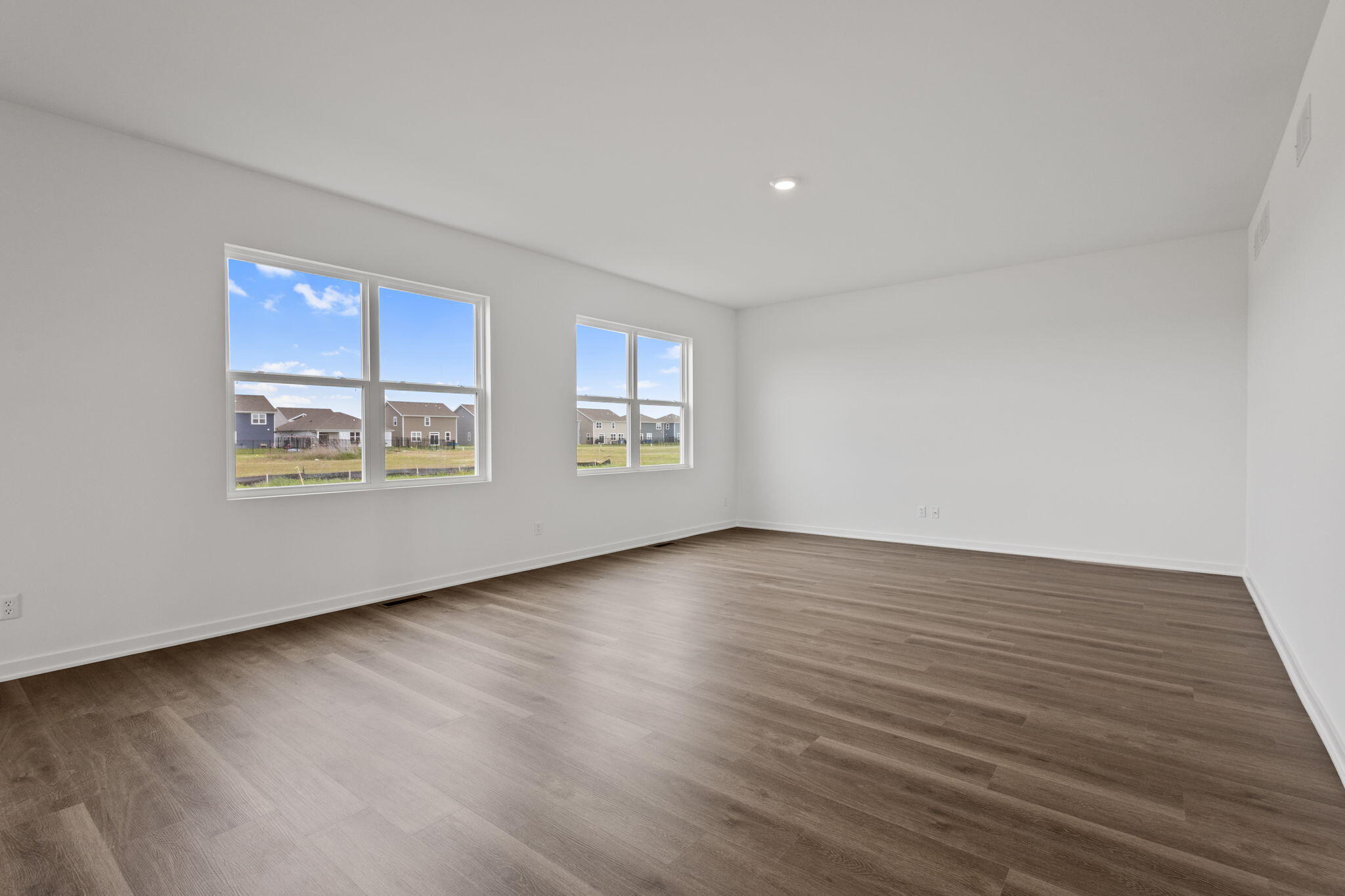10588 Morse Place Crown Point, IN 46307 - Photo 9 of 28 a view of an empty room with wooden floor and a window