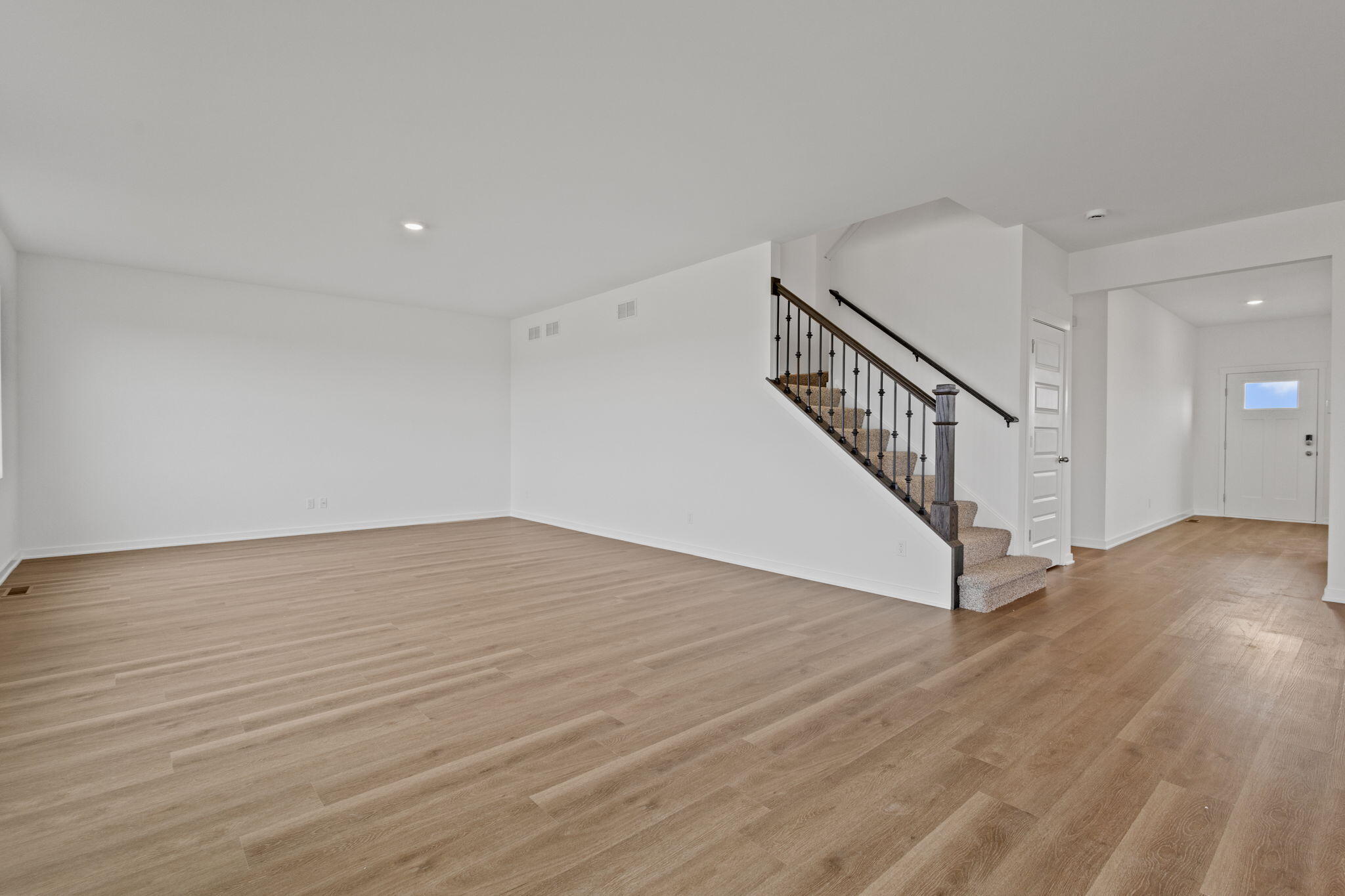 10588 Morse Place Crown Point, IN 46307 - Photo 10 of 28 a view of an empty room with wooden floor and stairs