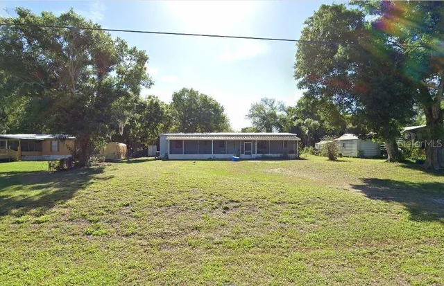 a swimming pool with outdoor seating and yard