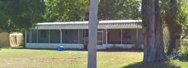a view of a house with a bath tub and a tree
