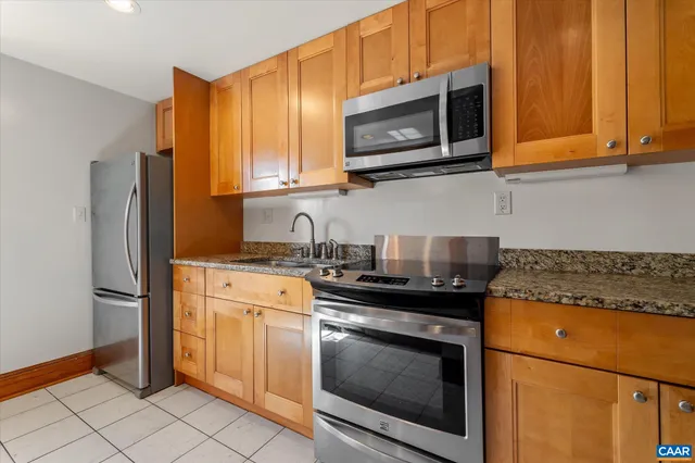 a view of empty room with wooden floor and fireplace