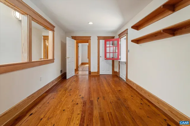 a view of a room with wooden floor