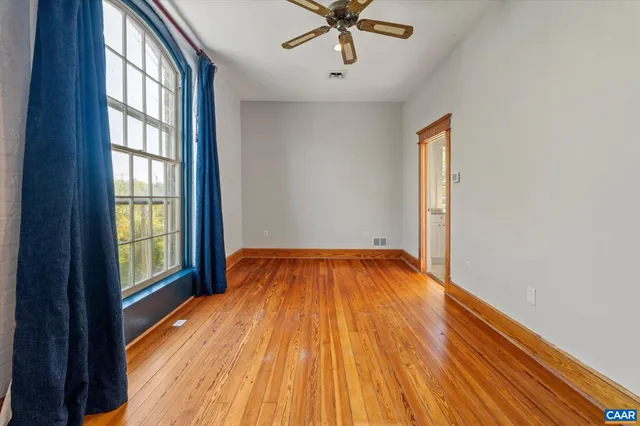 a bathroom with a granite countertop sink a mirror and a bathtub