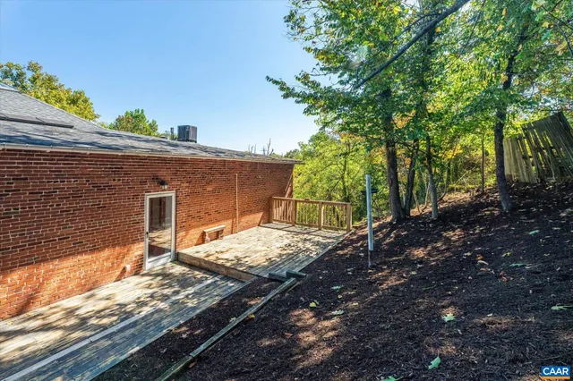 a view of a house with a chairs and table in a patio