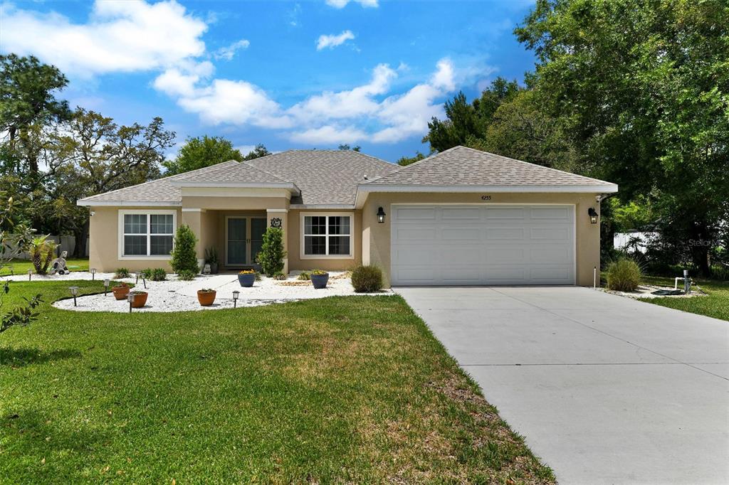 a front view of house with yard patio and green space