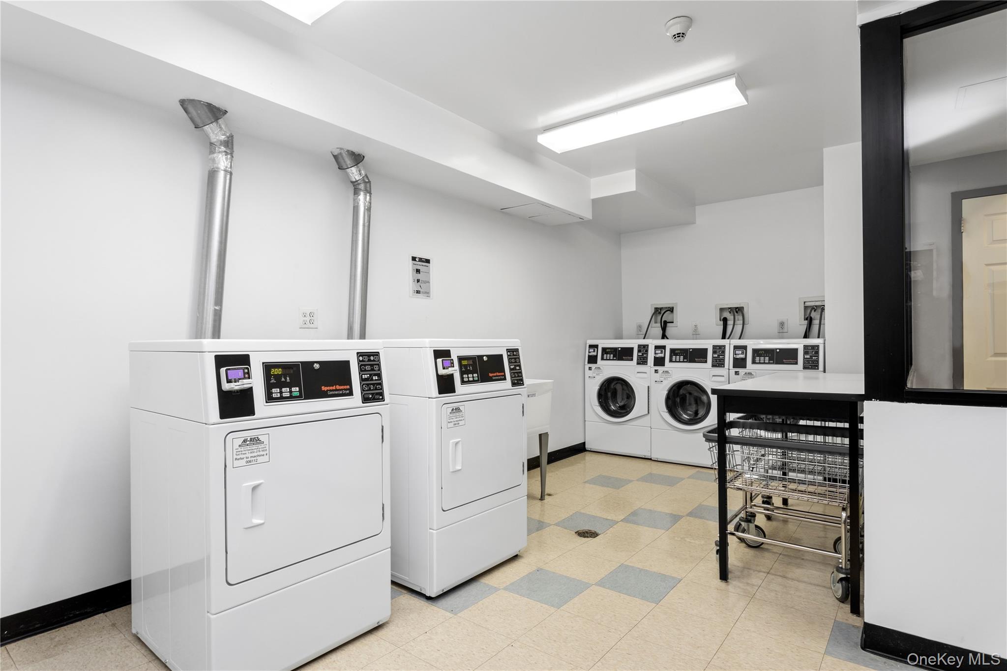108 Odell Clark Place, Unit 5C Manhattan, NY 10030 - Photo 9 of 15 a utility room with dryer and washer