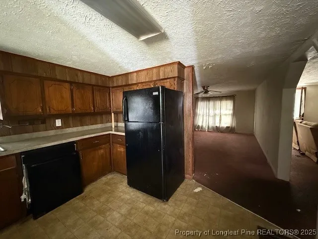 a kitchen with refrigerator and window