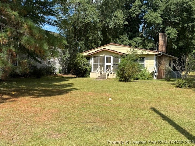 435 West Connecticut Avenue Southern Pines, NC 28387 - Photo 2 of 35 a front view of a house with a yard