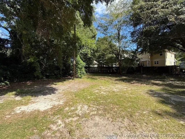 a view of a backyard with large trees