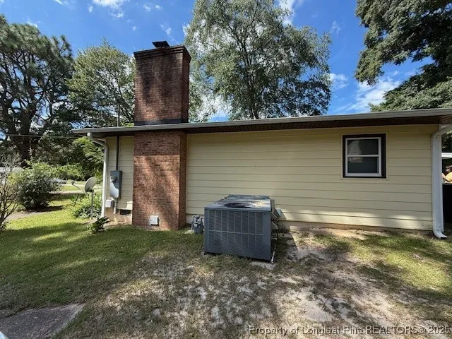 a backyard of a house with barbeque oven and outdoor seating