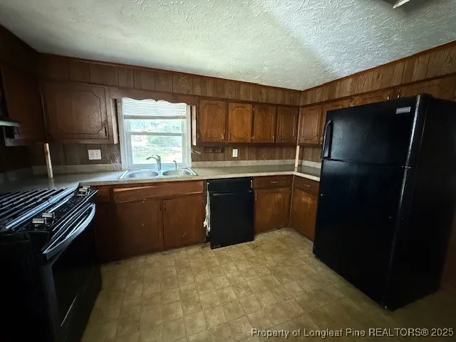 a kitchen with a sink stove and refrigerator
