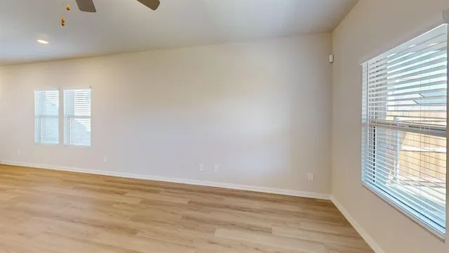 wooden floor in an empty room with a window