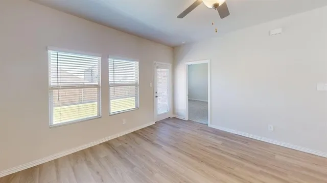 wooden floor in an empty room with a window