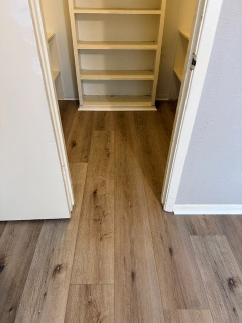 5102 Parsley Avenue Baytown, TX 77521 - Photo 11 of 19 a view of closet with wooden floor and stairs