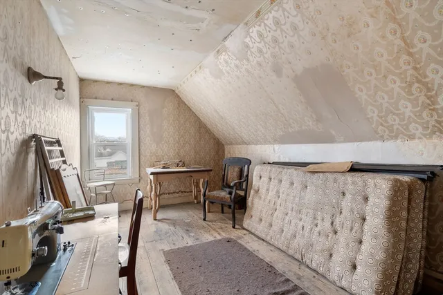 a view of a room with furniture and wooden floor