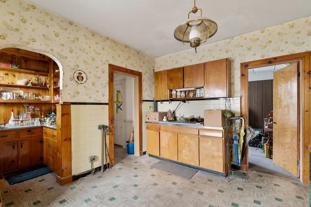 a kitchen with stainless steel appliances granite countertop a refrigerator a stove and a sink with wooden floor