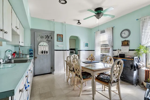 a view of a dining room with furniture and a chandelier