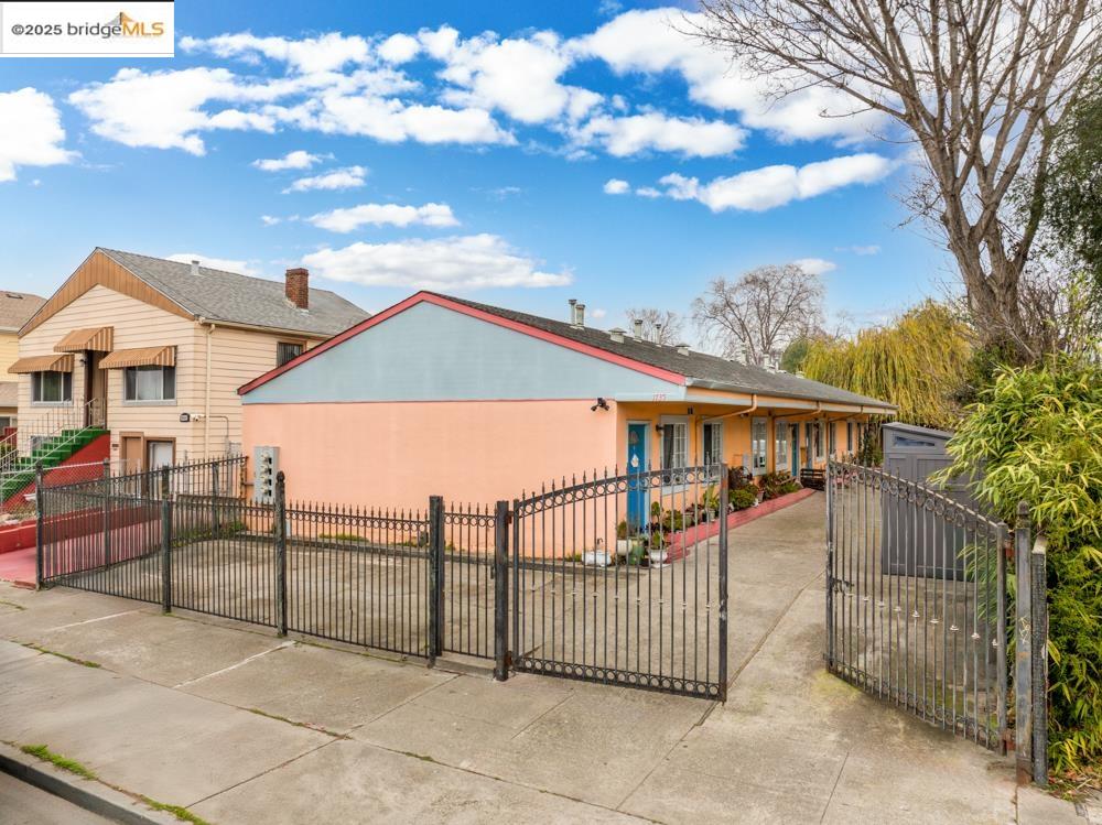 a view of a house with iron fence
