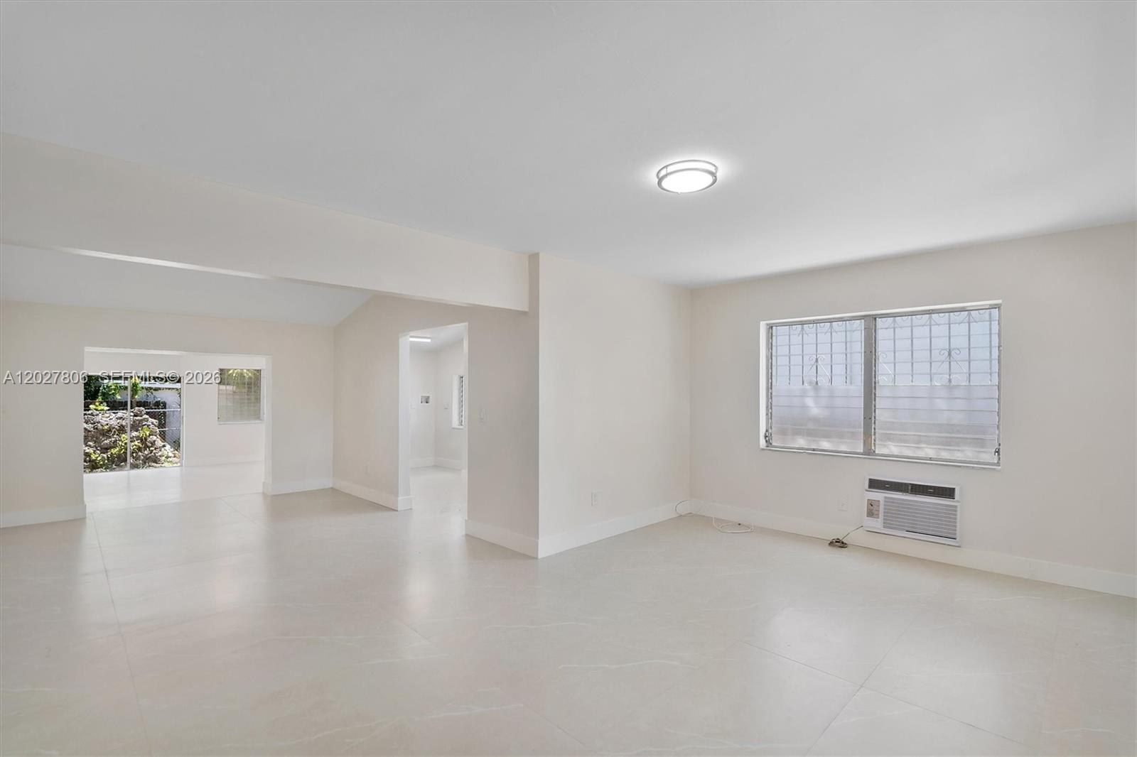 1612 Southwest 23rd Street, Unit 1612 Miami, FL 33145 - Photo 8 of 42 wooden floor in an empty room with a window