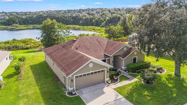 an aerial view of a house with big yard