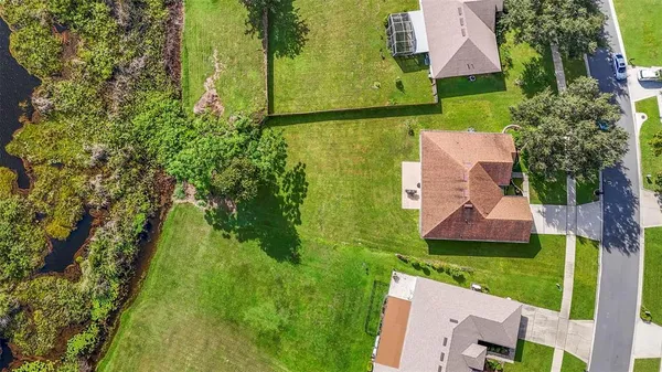 an aerial view of house with yard swimming pool and outdoor seating