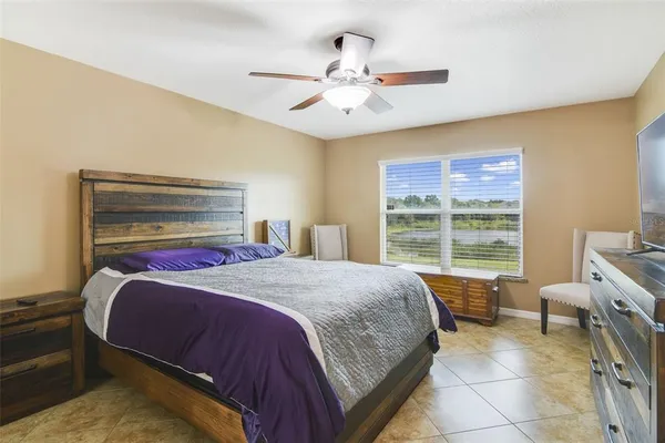 a bedroom with a bed and a window