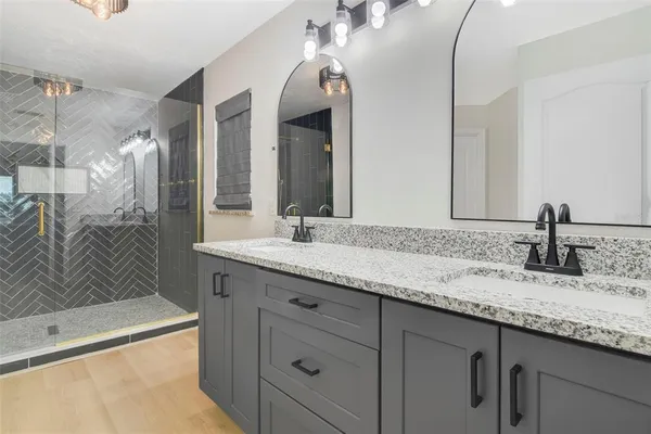 a bathroom with a granite countertop sink mirror and double