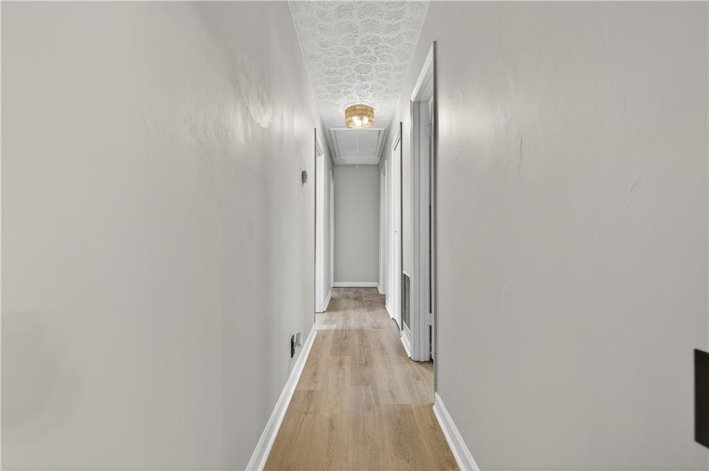 237 Lusk Court Canton, GA 30114 - Photo 11 of 25 a view of a hallway with wooden floor