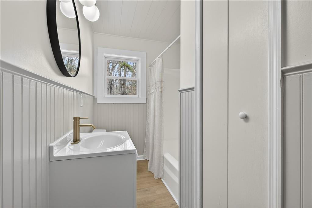 237 Lusk Court Canton, GA 30114 - Photo 12 of 25 a bathroom with a sink a light fixture and a mirror