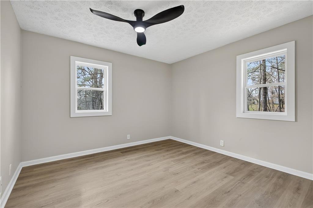 237 Lusk Court Canton, GA 30114 - Photo 14 of 25 a view of a big room with wooden floor and windows