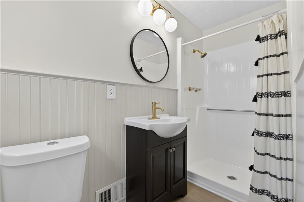 237 Lusk Court Canton, GA 30114 - Photo 16 of 25 a bathroom with a sink a toilet and a mirror