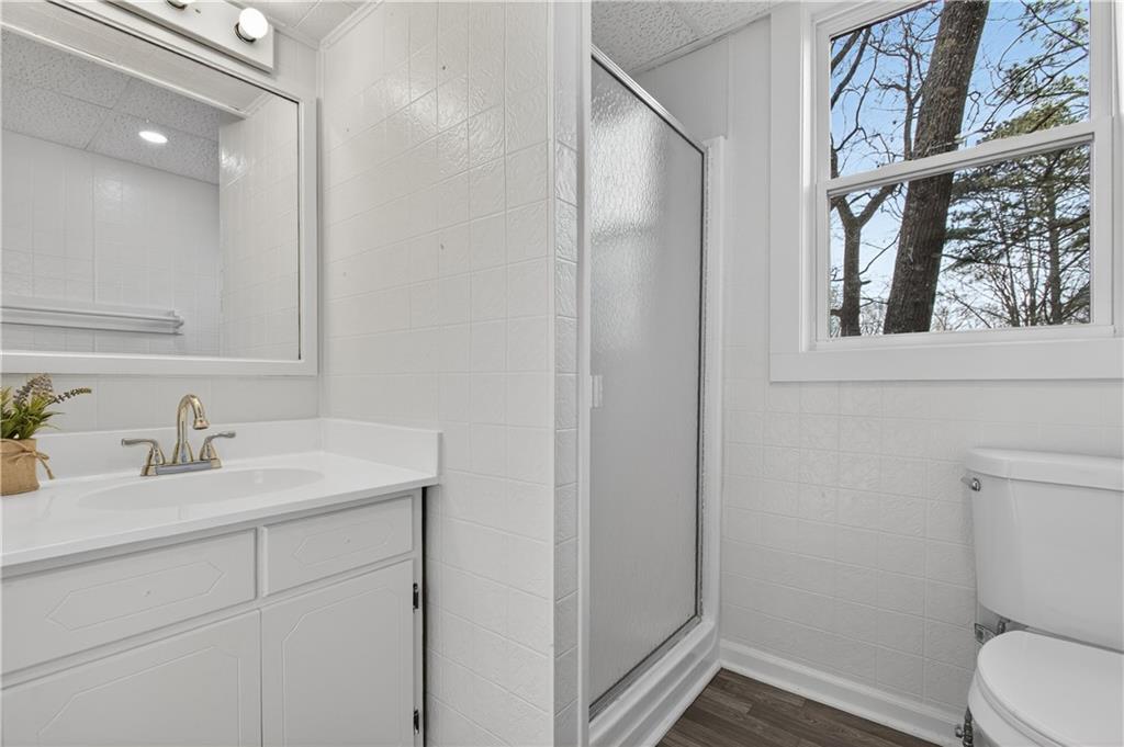 237 Lusk Court Canton, GA 30114 - Photo 19 of 25 a bathroom with a toilet sink vanity and mirror