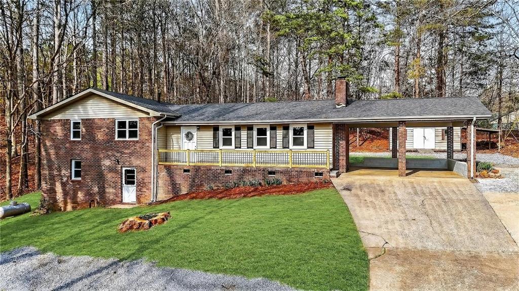 237 Lusk Court Canton, GA 30114 - Photo 2 of 25 a front view of a house with a yard table and chairs