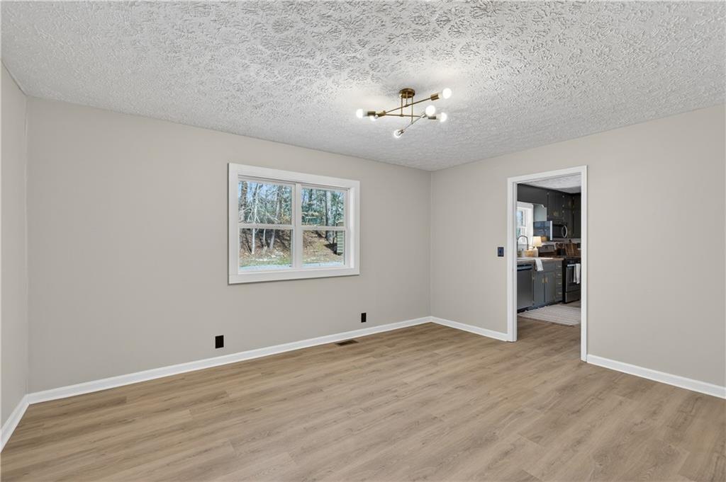 237 Lusk Court Canton, GA 30114 - Photo 9 of 25 wooden floor in an empty room with a window