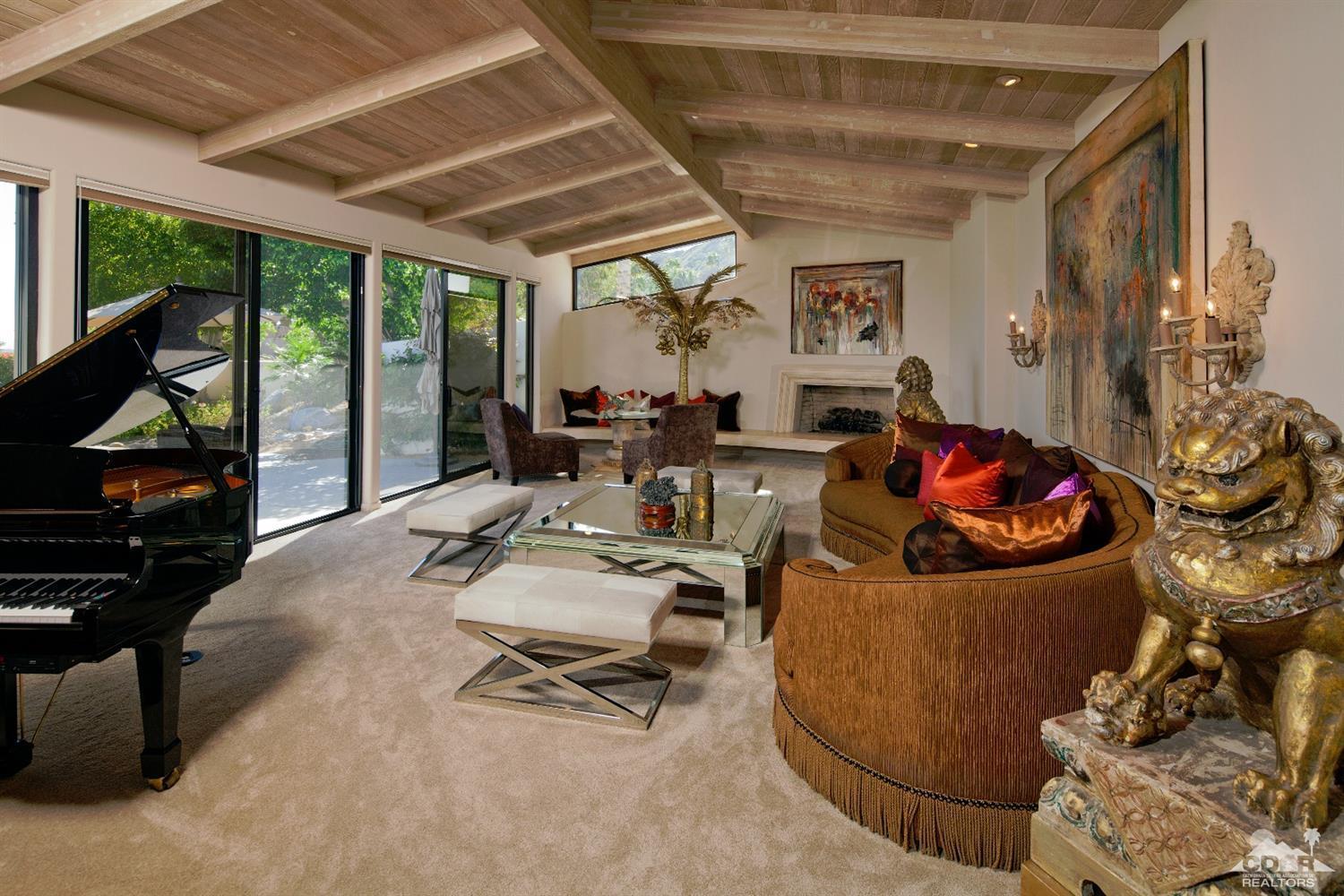 40815 Tonopah Road Rancho Mirage, CA 92270 - Photo 13 of 44 a living room with furniture a rug and a large window