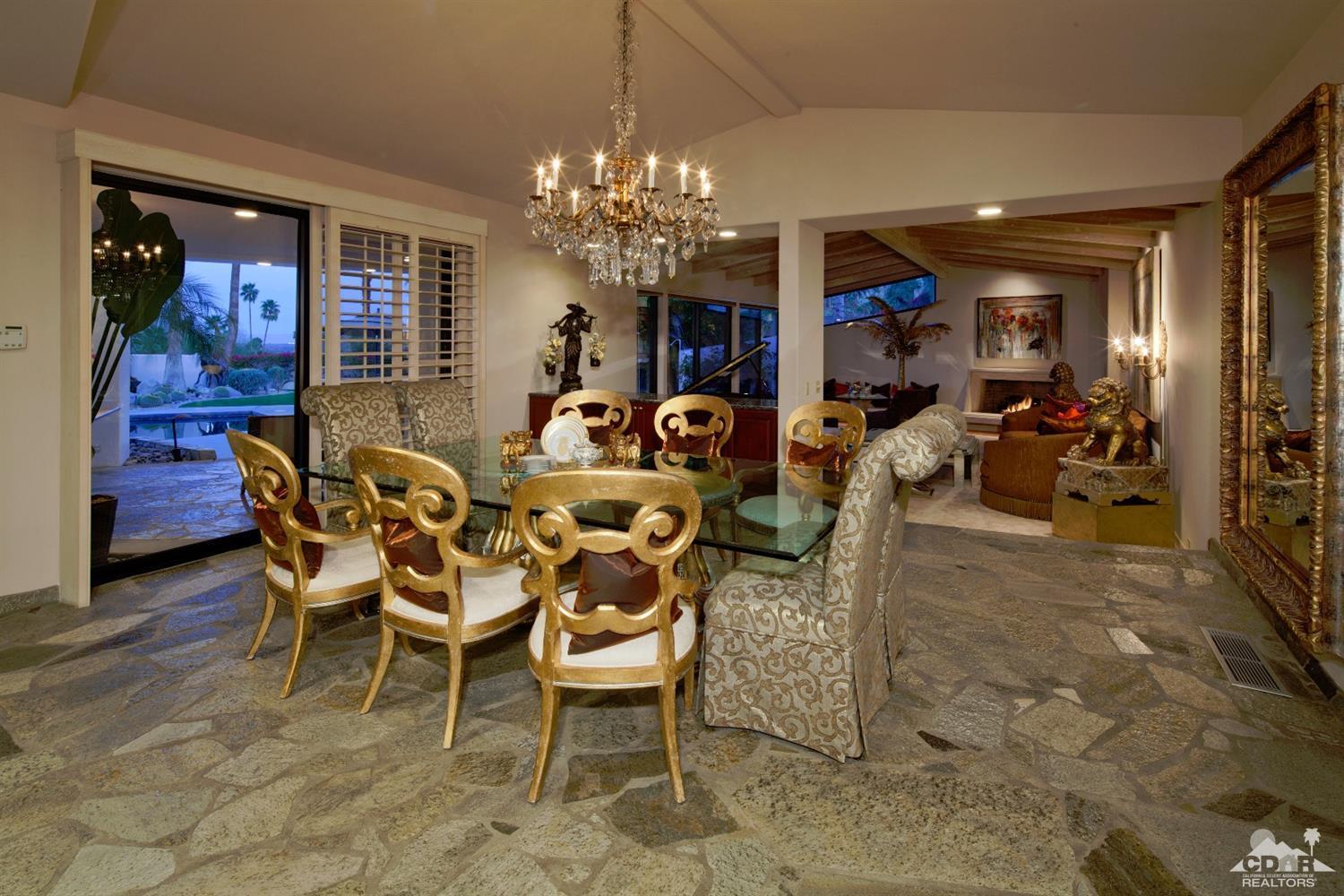 40815 Tonopah Road Rancho Mirage, CA 92270 - Photo 16 of 44 a dining room with furniture a chandelier and window
