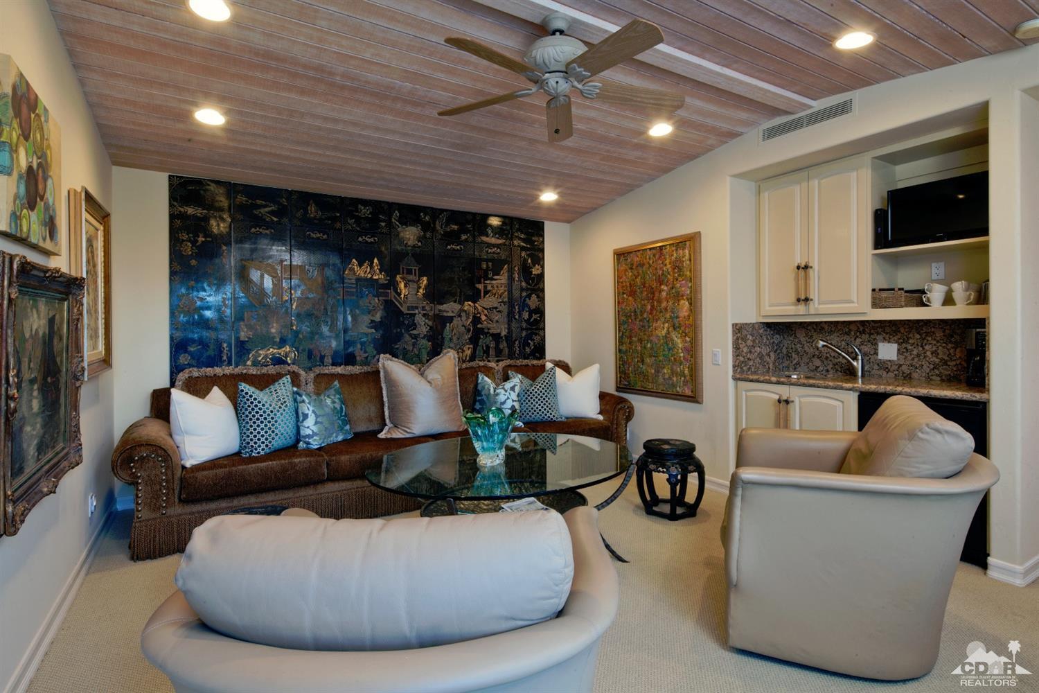 40815 Tonopah Road Rancho Mirage, CA 92270 - Photo 19 of 44 a living room with furniture a flat screen tv and a fireplace
