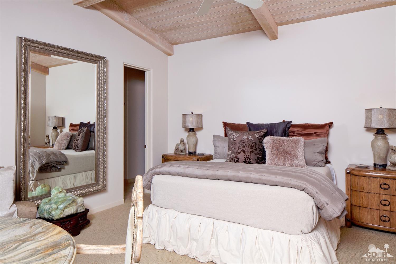 40815 Tonopah Road Rancho Mirage, CA 92270 - Photo 25 of 44 a bedroom with a bed and a couch