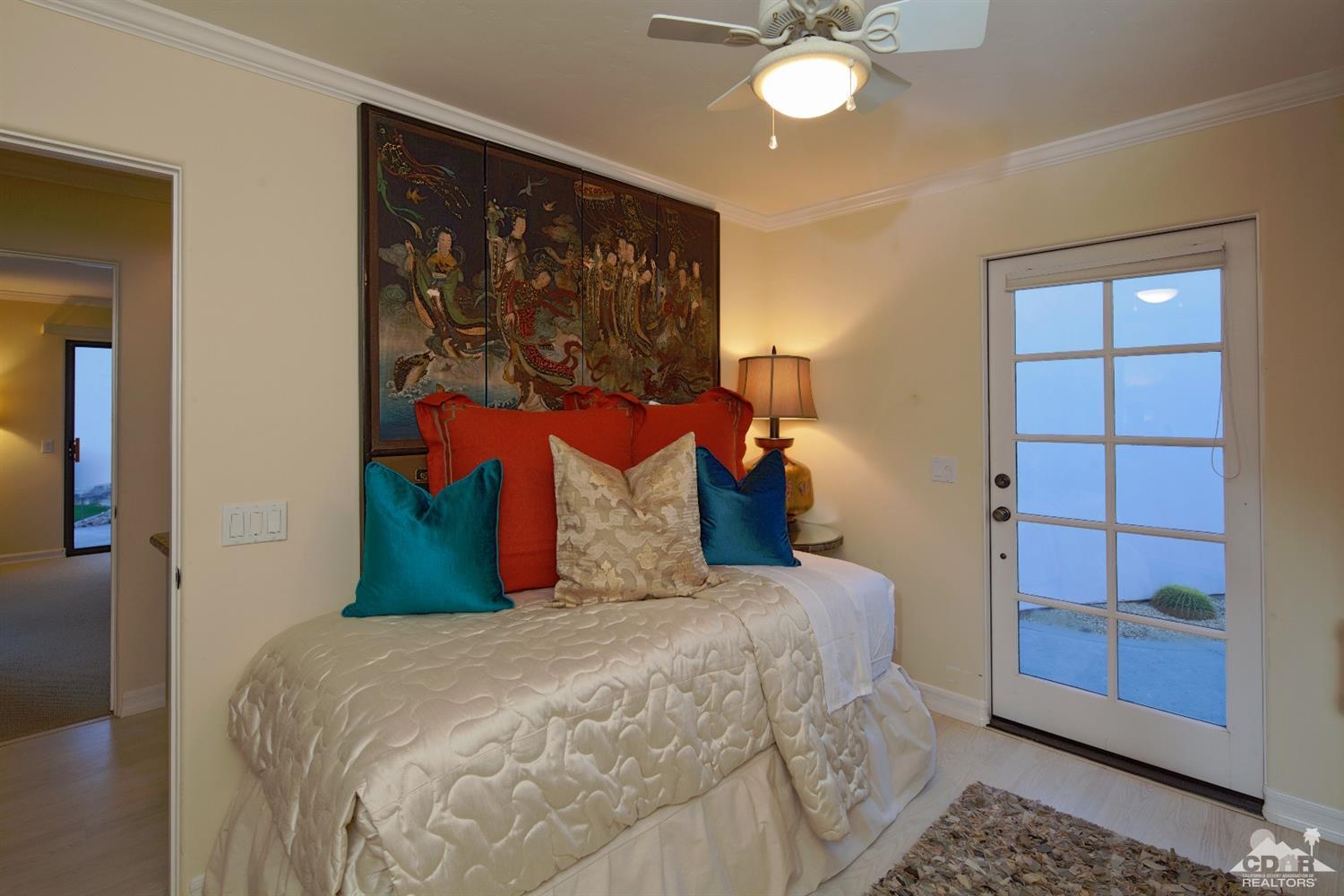 40815 Tonopah Road Rancho Mirage, CA 92270 - Photo 27 of 44 a bedroom with a bed and a window