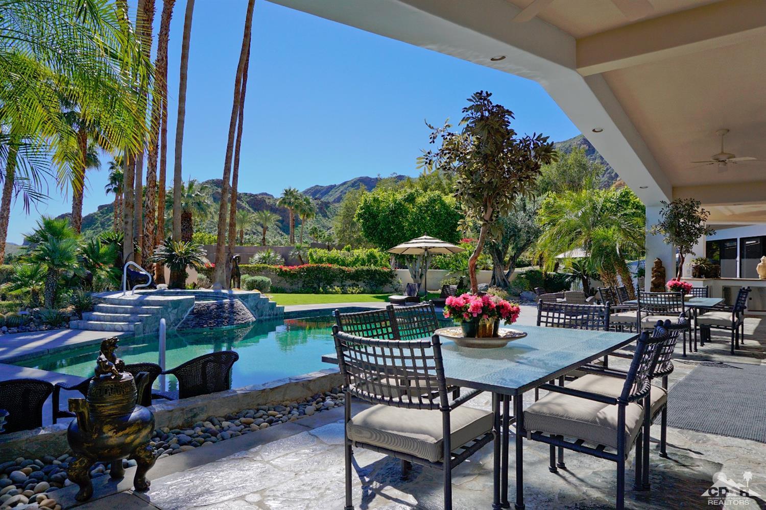 40815 Tonopah Road Rancho Mirage, CA 92270 - Photo 30 of 44 a table and chairs sitting in front of a building