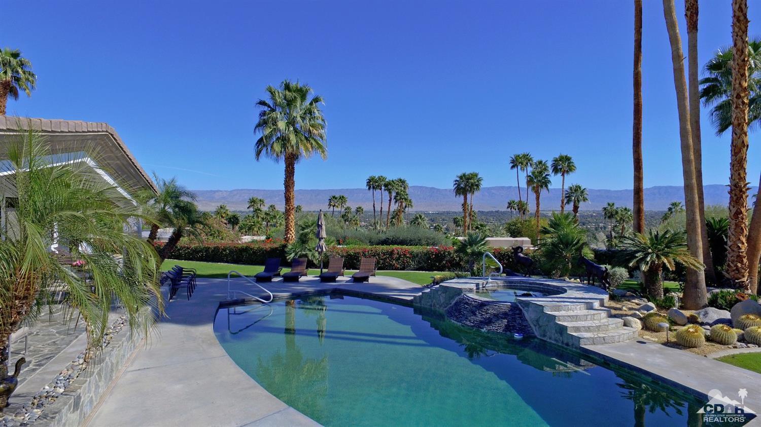 40815 Tonopah Road Rancho Mirage, CA 92270 - Photo 39 of 44 a view of a swimming pool and lounge chairs