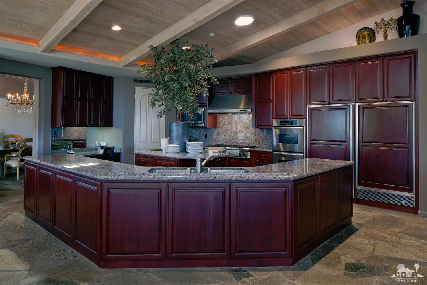 40815 Tonopah Road Rancho Mirage, CA 92270 - Photo 10 of 44 a kitchen with stainless steel appliances granite countertop a stove a refrigerator a sink and dishwasher
