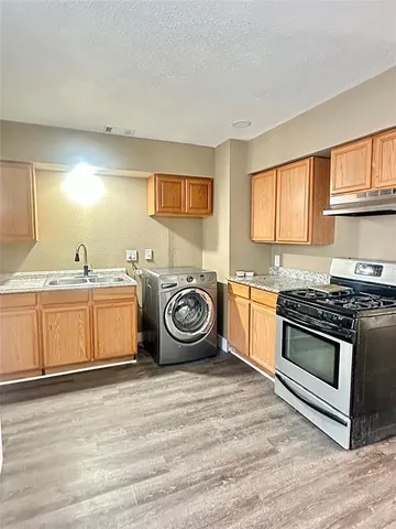 a utility room with sink dryer and washer