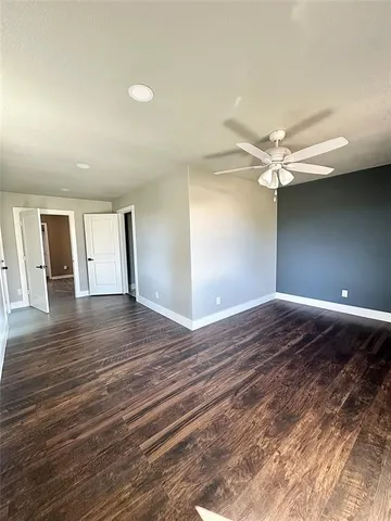 a view of a livingroom with wooden floor and window