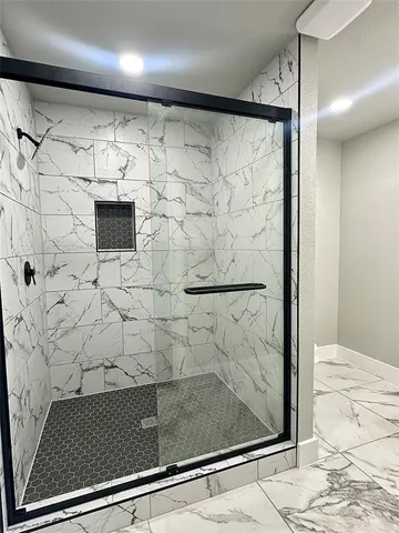 a bathroom with a shower and a sink